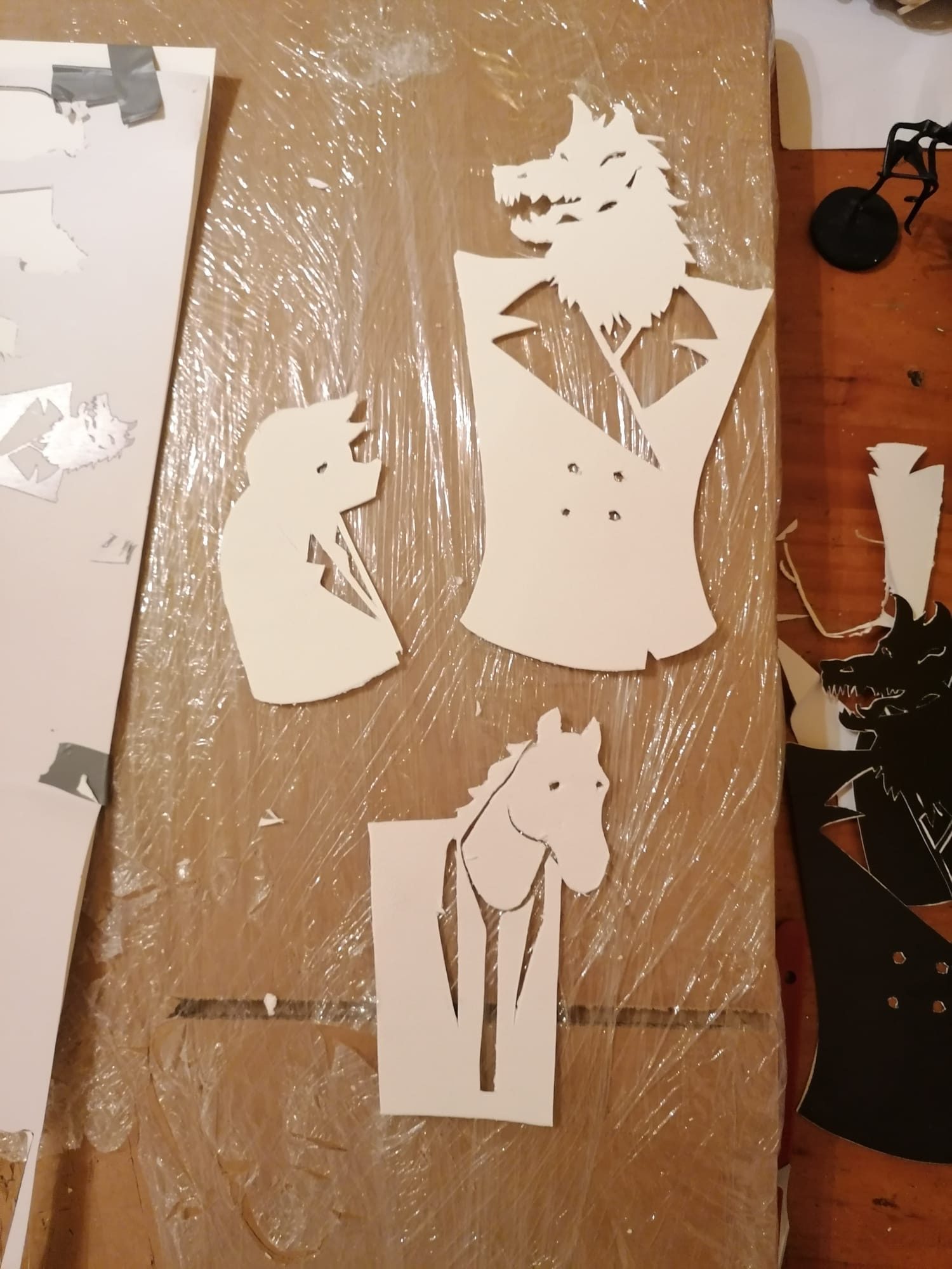 Finished cut-paper puppets laid out ready to shoot