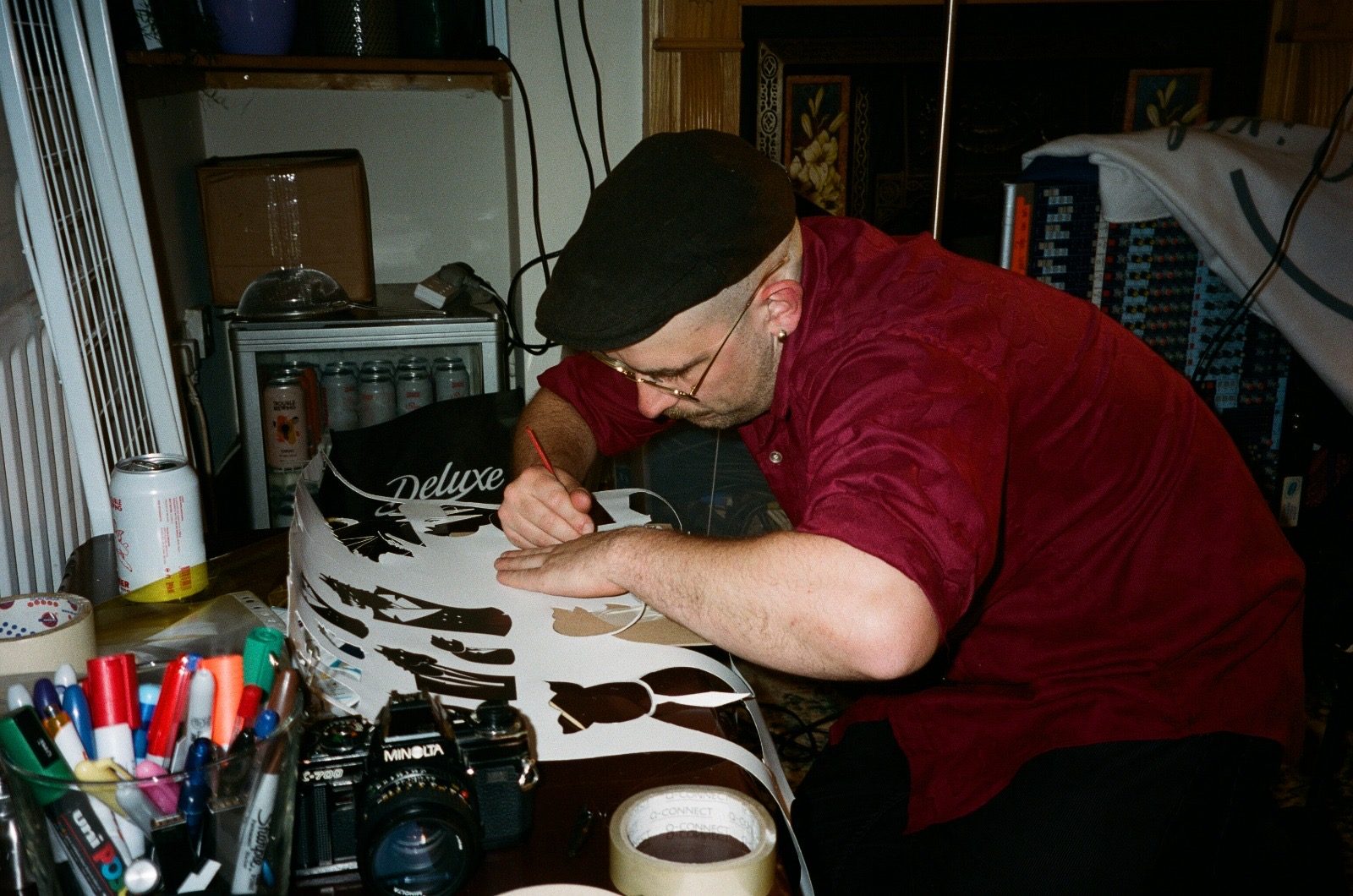 Cutting the paper puppets by hand at a workbench