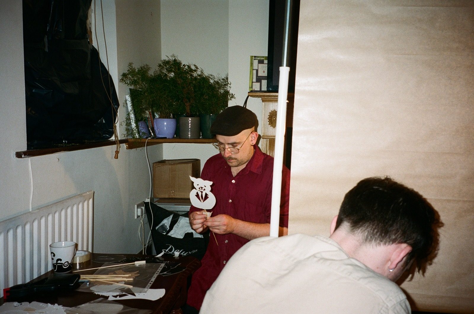 Two of the team working a puppet during a take