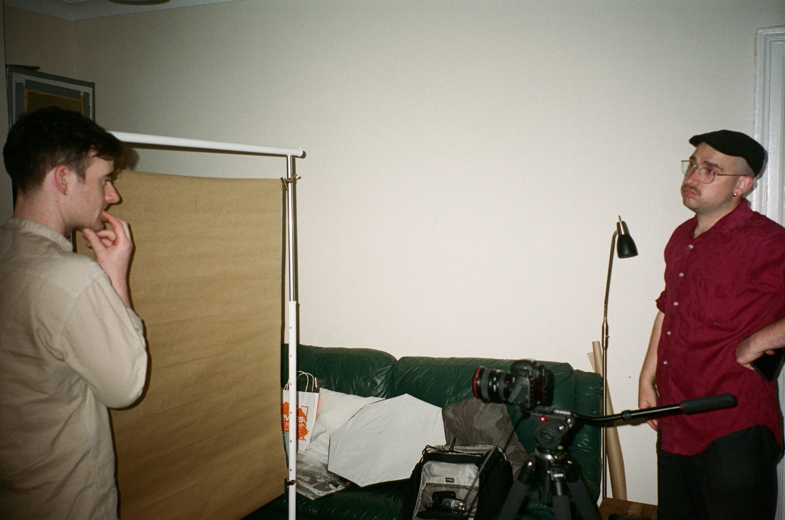 The room set up for a shooting day — screen, lamp, camera