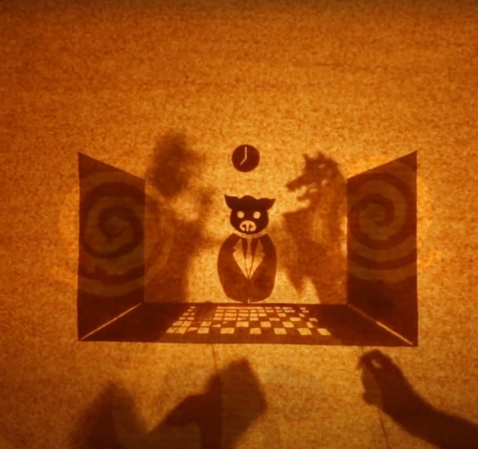 The lit shadow stage, a pig character framed by a paper proscenium
