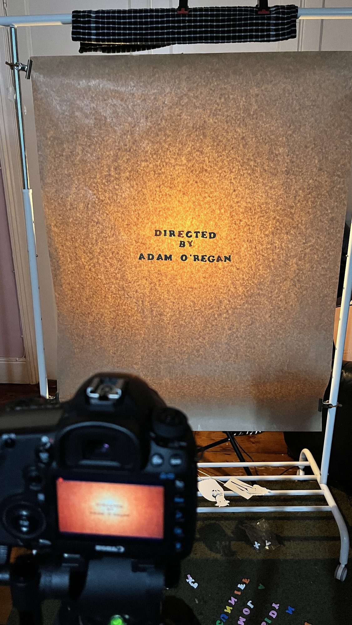 The ‘Directed by Adam O’Regan’ title card on the same lit screen