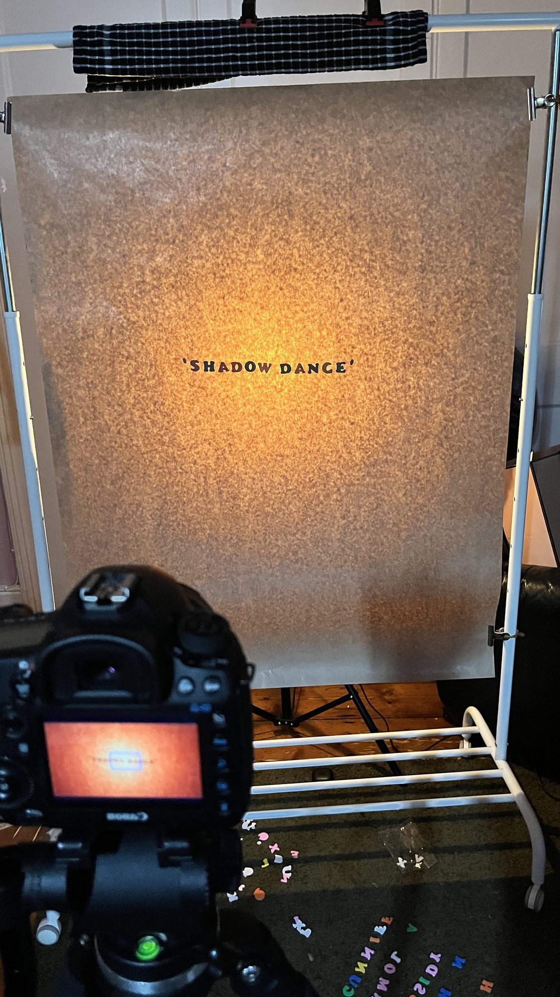 The ‘Shadow Dance’ title card, cut from paper and shot on the rig